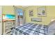 Inviting bedroom featuring beach decor, a walkout to a balcony, and a flat screen tv at 206 Gondola Park Dr # 206, Venice, FL 34292