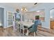 Open dining room with stylish decor, wood floors, and view into living room at 206 Gondola Park Dr # 206, Venice, FL 34292