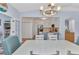 Open dining room showcasing wood floors, neutral colors, and view into kitchen at 206 Gondola Park Dr # 206, Venice, FL 34292