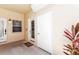 Covered entryway featuring two doors, a window, and view of tropical plants at 206 Gondola Park Dr # 206, Venice, FL 34292