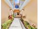 Condo entrance with walkway, decorative shrubs, and inviting lighting at 206 Gondola Park Dr # 206, Venice, FL 34292
