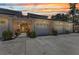 Inviting condo exterior with two-car garage, manicured bushes, and colorful sunset sky backdrop at 206 Gondola Park Dr # 206, Venice, FL 34292