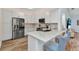 Bright kitchen featuring stainless steel appliances, sleek countertops, and modern bar seating at 206 Gondola Park Dr # 206, Venice, FL 34292