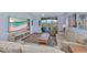 Bright living room featuring comfortable seating and a large TV at 206 Gondola Park Dr # 206, Venice, FL 34292