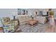 Cozy living room with plush seating, wood-look floors, and bright decor at 206 Gondola Park Dr # 206, Venice, FL 34292