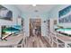 Dual workstations in home office with beach view on monitors, stylish décor and ample storage space at 206 Gondola Park Dr # 206, Venice, FL 34292