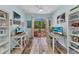 Bright office space with dual desks, beach-themed art, and access to an outdoor balcony at 206 Gondola Park Dr # 206, Venice, FL 34292