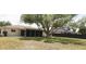 Large backyard with screened lanai, mature trees, and plenty of space for outdoor activities at 2119 Pellam Blvd, Port Charlotte, FL 33948