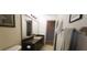 Bathroom featuring a large mirror, neutral paint, a vanity with storage, and tile floors at 2119 Pellam Blvd, Port Charlotte, FL 33948