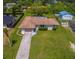 Well-maintained home featuring a long driveway and large grassy front yard at 2119 Pellam Blvd, Port Charlotte, FL 33948