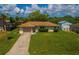 Charming single story house with a well-kept lawn and inviting curb appeal at 2119 Pellam Blvd, Port Charlotte, FL 33948
