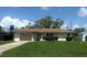 Charming single-story home with a well-maintained lawn and a one-car garage on a sunny day at 2119 Pellam Blvd, Port Charlotte, FL 33948