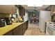 A well-lit kitchen adjacent to the dining area features updated appliances at 2119 Pellam Blvd, Port Charlotte, FL 33948