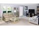 Inviting living room with large windows, neutral walls and carpeting at 2119 Pellam Blvd, Port Charlotte, FL 33948