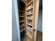 Well-stocked pantry with shelving for organized storage of spices and household goods at 2119 Pellam Blvd, Port Charlotte, FL 33948