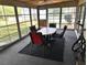 Enclosed patio with multiple windows providing natural light; includes table and chairs at 2119 Pellam Blvd, Port Charlotte, FL 33948