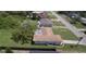 Back exterior view showing a cozy home, spacious yard, and tree shading the property at 2119 Pellam Blvd, Port Charlotte, FL 33948