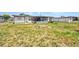 View of the backyard showing the patio, small outbuilding, and ample yard space at 2465 Deedra St, Port Charlotte, FL 33952