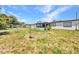 Spacious backyard with covered patio and view of neighborhood, perfect for outdoor activities at 2465 Deedra St, Port Charlotte, FL 33952