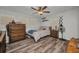 Bright bedroom with ceiling fan, wood-look floors, and two side tables at 2465 Deedra St, Port Charlotte, FL 33952