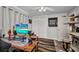 Bedroom with a large desk, wood-look floors, ceiling fan, and striped rug at 2465 Deedra St, Port Charlotte, FL 33952