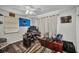 Bedroom with a ceiling fan, computer desk setup, wooden floors, natural light and ample space at 2465 Deedra St, Port Charlotte, FL 33952