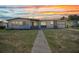 Charming single story home featuring stone accents, a manicured lawn and a welcoming walkway at 2465 Deedra St, Port Charlotte, FL 33952