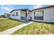 Close up view of a one story home featuring nice landscaping and a walkway to the entrance at 2465 Deedra St, Port Charlotte, FL 33952