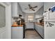 Efficient kitchen with gray cabinets, wooden countertops, modern appliances, and a ceiling fan at 2465 Deedra St, Port Charlotte, FL 33952