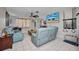 Well-lit living room with tile floors, reclining sofas, a ceiling fan, and a mounted television at 2465 Deedra St, Port Charlotte, FL 33952
