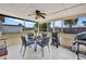 Screened in patio area with plenty of seating, ceiling fan, and grill at 2465 Deedra St, Port Charlotte, FL 33952