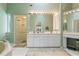 Bright primary bathroom with a glass door shower, soaking tub, and double vanity sink at 2521 W Marion Ave # 912, Punta Gorda, FL 33950