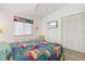 Inviting bedroom with a colorful bedspread, and television at 2521 W Marion Ave # 912, Punta Gorda, FL 33950