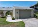 Charming home featuring a well-manicured lawn, lush landscaping, and an attached two-car garage at 2521 W Marion Ave # 912, Punta Gorda, FL 33950