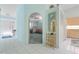 Inviting hallway with white tile flooring leading to the kitchen and a cozy living area at 2521 W Marion Ave # 912, Punta Gorda, FL 33950