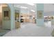 Bright and airy kitchen with skylights, white tile floors, and light wood cabinets at 2521 W Marion Ave # 912, Punta Gorda, FL 33950