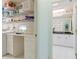 Laundry room with built-in ironing station leading to bathroom with floral wallpaper at 2521 W Marion Ave # 912, Punta Gorda, FL 33950