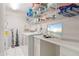 Well-organized laundry area with shelving, washer, dryer, and built-in desk at 2521 W Marion Ave # 912, Punta Gorda, FL 33950