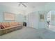 Inviting living room with a large closet, plush carpet, and artwork on the pale blue walls at 2521 W Marion Ave # 912, Punta Gorda, FL 33950