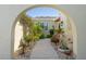 Arched walkway leading to front door of the villa, showcasing beautiful landscaping at 2521 W Marion Ave # 912, Punta Gorda, FL 33950