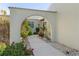 Arched walkway leading to front door of the villa, showcasing beautiful landscaping at 2521 W Marion Ave # 912, Punta Gorda, FL 33950