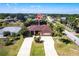 Spacious single-Gathering home with a large front yard, palm trees and a long driveway on a sunny day at 25538 Rampart Blvd, Punta Gorda, FL 33983