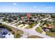 This aerial shot displays the neighborhood and the home's mature landscaping, and ideal location at 25538 Rampart Blvd, Punta Gorda, FL 33983