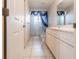 Cozy bathroom featuring single vanity and walk-in shower with blue curtains at 25538 Rampart Blvd, Punta Gorda, FL 33983