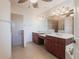 Bright bathroom featuring double sinks, shower, and soaking tub at 25538 Rampart Blvd, Punta Gorda, FL 33983