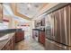Modern kitchen featuring stainless steel appliances, granite countertops, and ample cabinet space for efficient cooking at 25538 Rampart Blvd, Punta Gorda, FL 33983