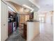 Well-equipped kitchen featuring stainless steel appliances and dark wood cabinetry and a breakfast bar at 25538 Rampart Blvd, Punta Gorda, FL 33983