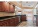 Spacious kitchen with wooden cabinetry, granite countertops, and stainless steel appliances, ideal for cooking enthusiasts at 25538 Rampart Blvd, Punta Gorda, FL 33983