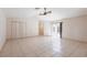 Open concept living room with tile floors and sliding glass doors leading to outdoor area at 25538 Rampart Blvd, Punta Gorda, FL 33983