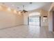Open-concept living area featuring sliding glass doors, neutral color palette, and tile flooring for modern living at 25538 Rampart Blvd, Punta Gorda, FL 33983